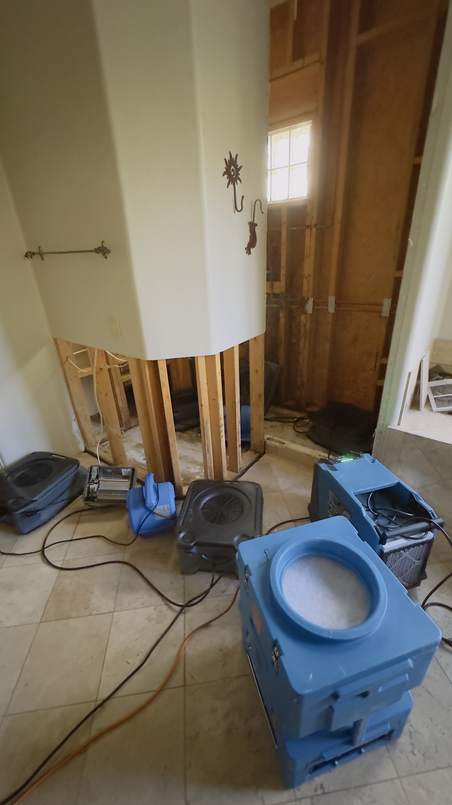 Kitchen mid-restoration with multiple drying units in place